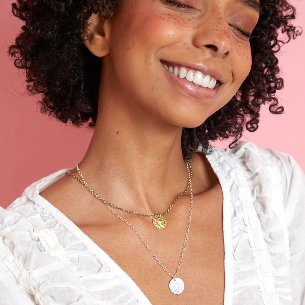 Model wearing brass and silver full moon necklaces 