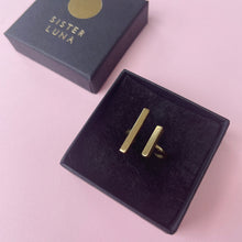 Load image into Gallery viewer, Close up of brass bar ring in box 
