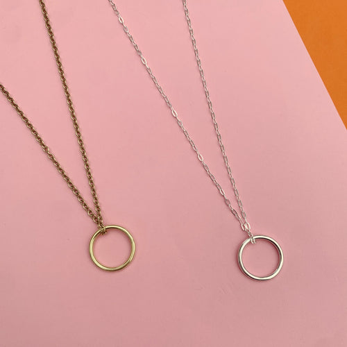 New moon necklaces, brass and silver, flat lay 